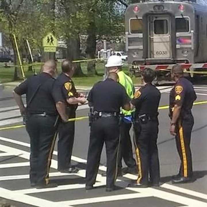 City police confer with NJ Transit worker.