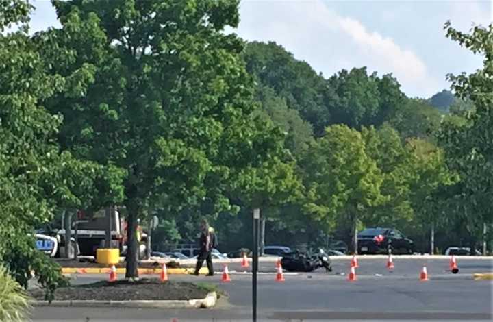 The motorcyclist took off -- and collided with another car outside the Floor and Decor store, witnesses said.