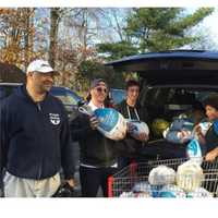 <p>People to People volunteers collect frozen turkeys for the Nanuet food bank.</p>