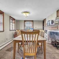 <p>The dining area kept the original fireplace.</p>