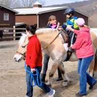 <p>A young client of Pony Power rides at the Three Sisters Farm in Mahwah, N.J.</p>