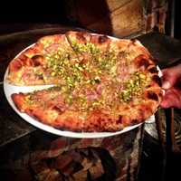 <p>Pizzeria Posto&#x27;s Morandi pie sports pistachios, red onions, and rosemary.</p>