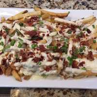 <p>The blue cheese and bacon smothered fries at Barnum Publik House in Bridgeport.</p>