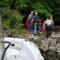 <p>Rappel team brought by Palisades Interstate Parkway Police Marine Unit head toward victim.</p>