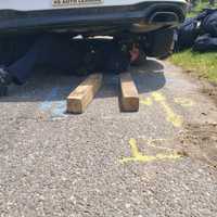 <p>Suffolk County Police officers work to free a kitten stuck in a wheel well in North Babylon Thursday, June 2.</p>