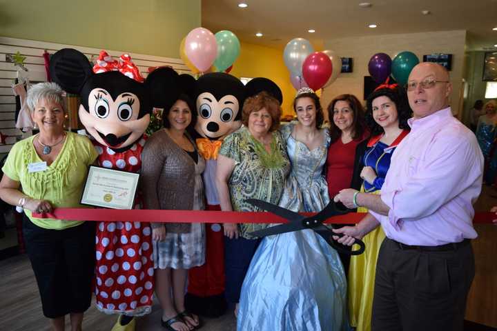 Rose Aglieco, Minnie Mouse, Nicole Aravena, Mickey Mouse, Donna Aravena, Cinderella, Margaret Carey, Snow White, Bill Flash, take part in the ribbon cutting.