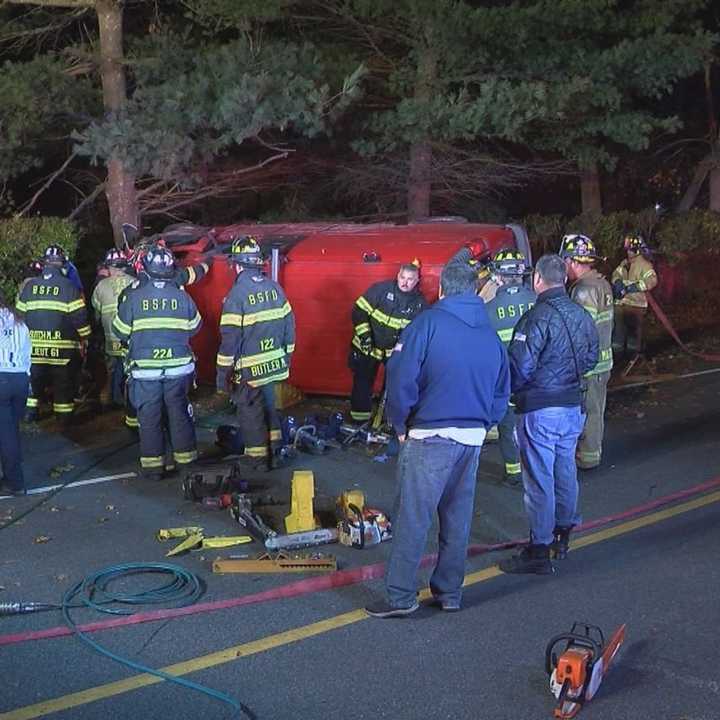 Two people had to be rescued from an overturned van after it slammed into a tree on Long Island.