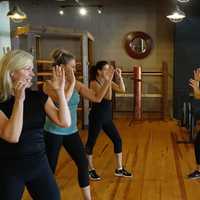 <p>Sally Cadoux, left, teaches young women personal safety measures.</p>