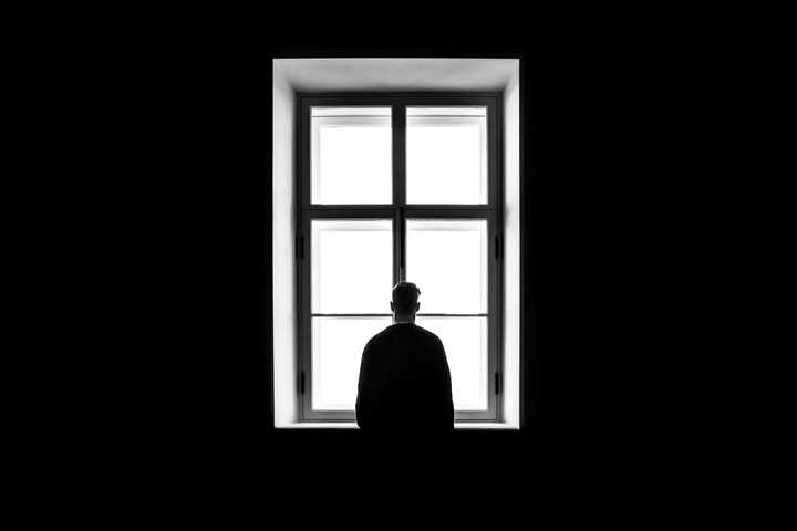 A person standing at a window.