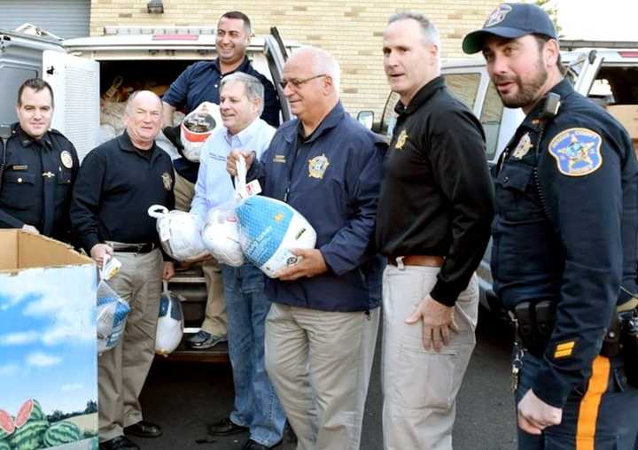 Bergen County Sheriff Michael Saudino with County Executive Jim Tedesco (to his right) and others delivering turkeys at the CFA in Saddle Brook. Far right is BCSO Officer Aret Yesilepe, who organized the first the drive 7 years ago.