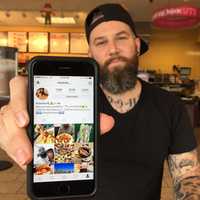 <p>Matt Savage of Garfield displays his Instagram in a Lodi Dunkin Donuts.</p>