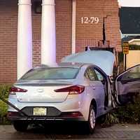 <p>A tow truck removed the Hyundai sedan after it slammed into the Provident Bank branch in Fair Lawn.</p>