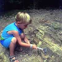 <p>Darlene Garrison&#x27;s nephew, Sebastian, frees a garnet during a visit to Roxbury a few years ago.</p>