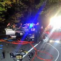 <p>Members of the Echo Hose Hook &amp; Ladder Co. 1 investigate the scene of a fatal head-on collision between two cars Thursday evening in Shelton. </p>