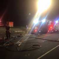 <p>Members of the Echo Hose Hook &amp; Ladder Co. 1 investigate the scene of a fatal head-on collision between two cars Thursday evening in Shelton. </p>