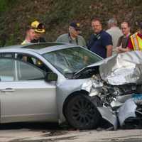 <p>First responders investigate the crash scene at Rive Road and Mt. Pleasant Road in Shelton on Wednesday.</p>