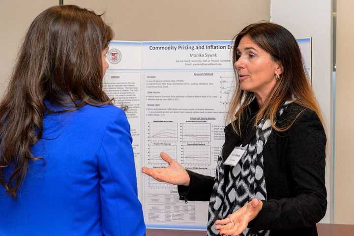 Sacred Heart University DBA candidate Monika Sywak, right, makes a presentation at the Stamford Graduate Center in November. 