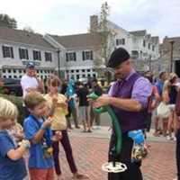 <p>An expert delights the kids as he makes balloon animals and hats at the Slice of Saugatuck festival in Westport.</p>