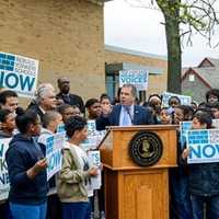 <p>Yonkers Mayor Mike Spano, at podium, speaks at a rally for a schools rebuilding project in front of the Martin Luther King Jr. Academy Wednesday morning.</p>