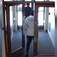 <p>The suspect and victim are seen in security camera stills from the bank.</p>