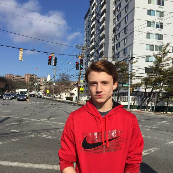 Stamford High student Christian Hamilton, with Stamford High in background. He said an announcement over the loudspeaker system told everyone to evacuate.