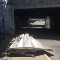 <p>The roof of a box truck that hit the Chestnut Street bridge in Suffern sits in the road Wednesday.</p>