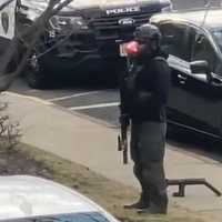 <p>Bergen County Regional SWAT Team member in front of the Saddle Brook apartment.</p>