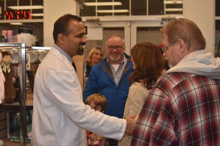 Alok Bhatt greets customers on the opening day of his Trumbull Pharmacy in November.