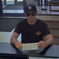 <p>New York State Police are looking for this bank robbery suspect, seen on camera, who allegedly passed a note to a teller at TD Bank in Fishkill demanding money.</p>