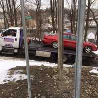 <p>The car that was hit by a Danbury-bound train on Tuesday afternoon is towed from the scene of the accident in Norwalk.</p>