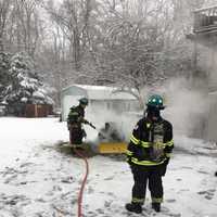 <p>Firefighters put out a tractor fire on Purdy Hill Road in Monroe on Saturday</p>