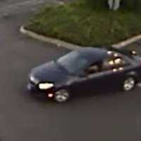 <p>Surveillance footage of the car that the credit card theft suspects are believed to be driving</p>