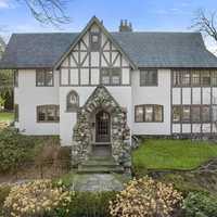 $3.25M Tudor-Style House In Newton Features Two-Tiered Deck With Built-In Gas Grill