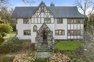 $3.25M Tudor-Style House In Newton Features Two-Tiered Deck With Built-In Gas Grill