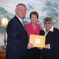 <p>Paul and Karen Van Ostenbridge present a donation to Eva&#x27;s Village on behalf of Atlantic Stewardship Bank&#x27;s tithing program. </p>