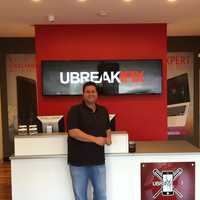 <p>Seth Berkman of Cortlandt Manor inside his new Mamaroneck location of uBreakiFix.</p>