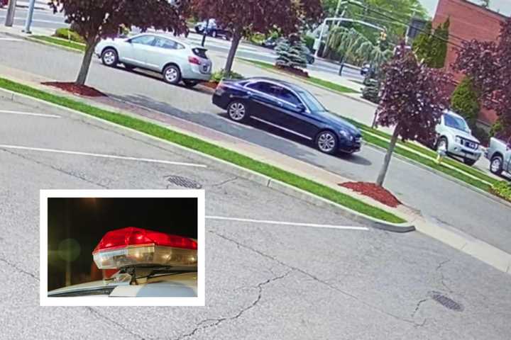 Police are searching for this dark blue four-door Mercedes sedan, the driver of which is accused of performing a lewd act in front of a teenage girl.