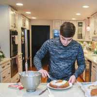 <p>Joseph DeCandia puts the finishing touches on his carrot cake.</p>