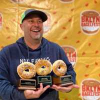 <p>The creator and owner Adam Goldberg showing off some of his trophies.</p>