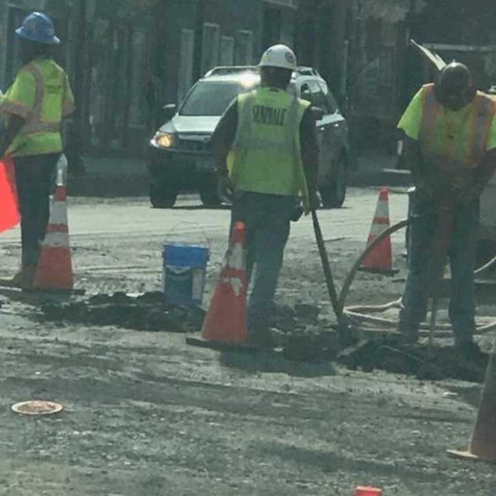 Workers in the area of Broadway and Lincoln Street.