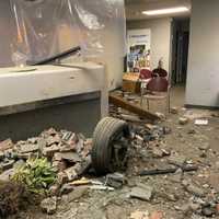 <p>A tire and a plant inside the building.</p>