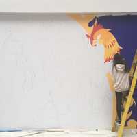 <p>Lao at work at on the mural at the Galleria in White Plains.</p>