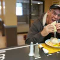 <p>A customer eats an empanada at Soto&#x27;s new restaurant.</p>