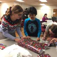 <p>Approximately 30 children participated in this annual tradition, and together they wrapped more than 50 presents.</p>