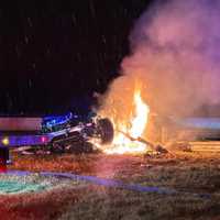 <p>A Tesla electric vehicle burns on Interstate 95 in Wakefield Thursday night following a single-vehicle crash.</p>