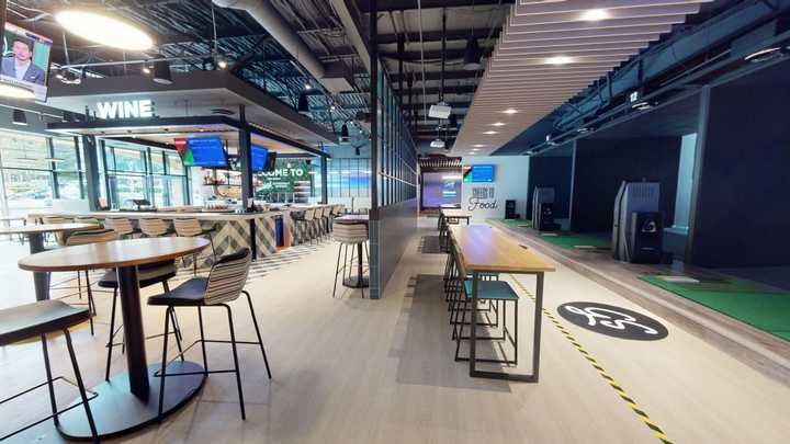 The inside of Golfzon Social in Scarsdale, a golf simulator that also serves food and drinks.