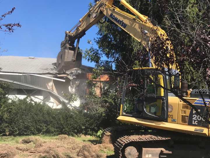 A zombie home is torn down on Long Island.