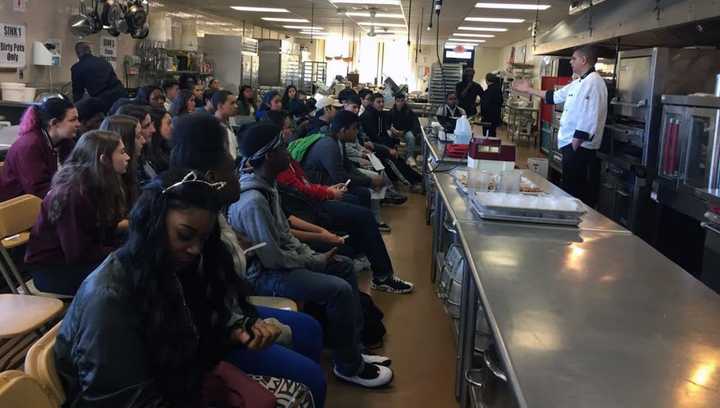 Chef John Damiano, an instructor in the BOCES Culinary Arts Program, talk to the visiting students at a career conference.