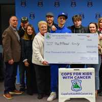Lowell Police Gift $5,000 Check To Retired Officer's Son Battling Cancer
