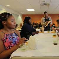 <p>Kids enjoy a celebration of summer meals in the community room of the Martin Luther King Jr. Apartments in Stamford.</p>